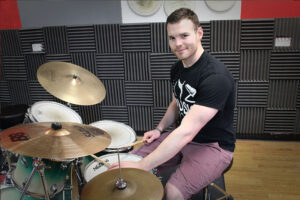 Duncan playing a drum kit