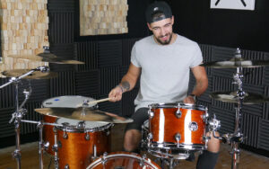 Max playing drum kit