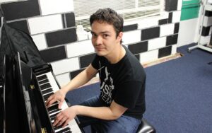 John playing the piano