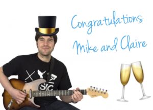 Michael playing guitar with a top hat and champagne glasses
