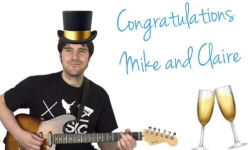 Michael playing guitar with a top hat and champagne glasses