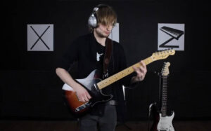 Seb playing guitar in his tutor cover