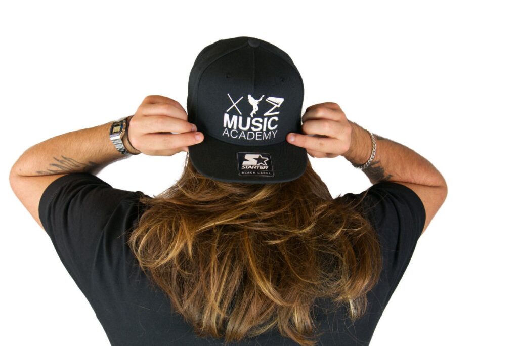 Max wearing the XYZ Music Academy snapback backwards