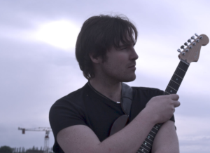 Michael holding the guitar